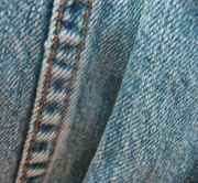 Part of a pair of denim blue jeans