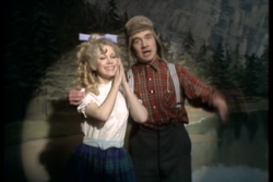Michael Palin wears a flannel shirt as he performs The Lumberjack Song.