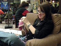 This woman is knitting at a coffee shop; although it can be done by one person alone, knitting is very much a social activity. There are many knitting guilds and other knitting groups.