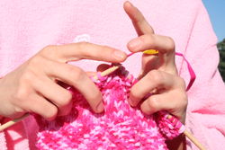 A little dexterity is helpful in working with knitting needles 