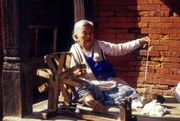 A hand-turned spinning wheel in action